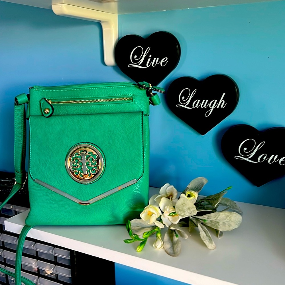 Beautiful bright green crossover bag with gold detail.